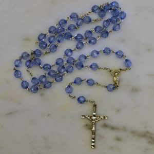 Elegant centerpiece depicting Our Blessed Mother - Vibrant, sapphire-blue glass beads - Highly detailed pewter Crucifix - Includes "How to Pray the Rosary" folder - Blessed by the Vincentian Priests of Our Lady of Angels - Comes with a blue velveteen pouch