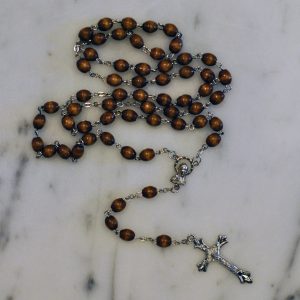 Elegant centerpiece depicting Our Blessed Mother - wooden beads - Highly detailed pewter Crucifix - Includes "How to Pray the Rosary" folder - Blessed by the Vincentian Priests of Our Lady of Angels - Comes with a blue velveteen pouch